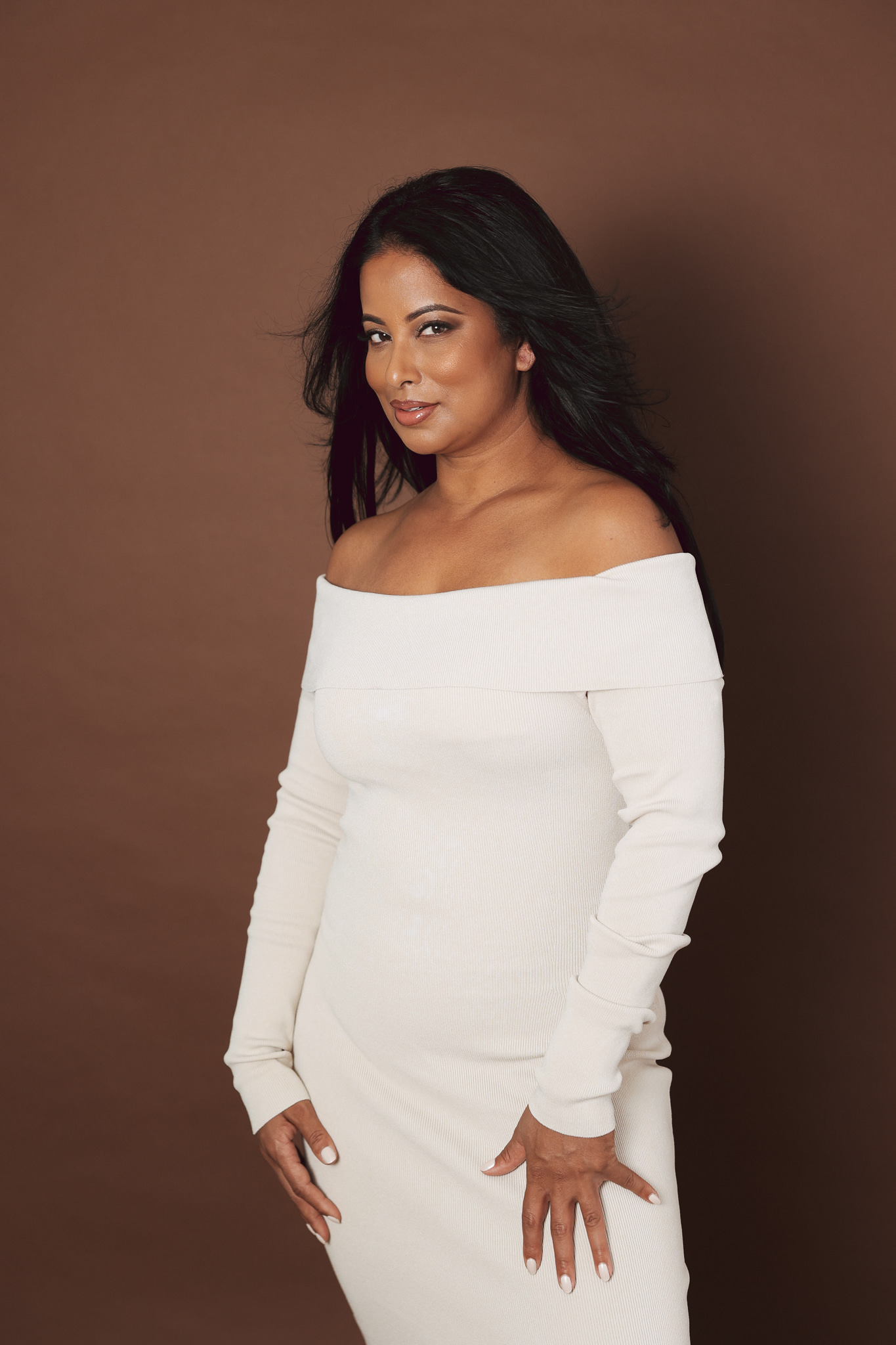 Roshani Patel in an off-the-shoulder cream dress